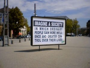 Sign saying: Imagine a society in which ordinary people gain more influence and greater control over their lives.