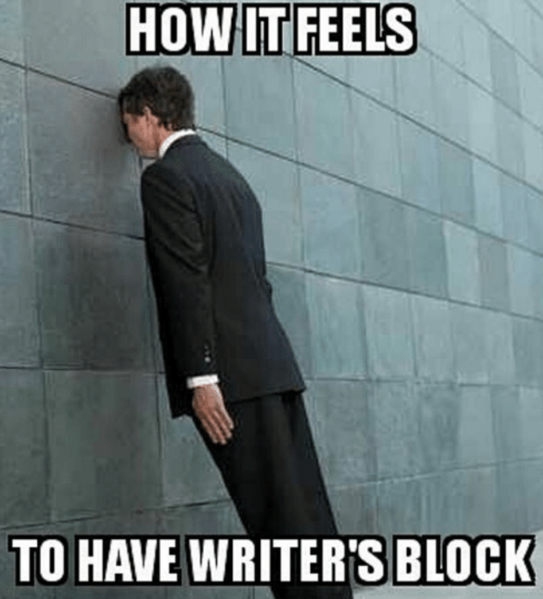 a man in a suit presses his head against a wall with words reading, "How it feels to have writer's block"