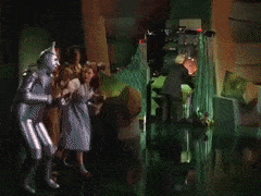 animated gif showing Dorothy and her friends pulling back the curtain to reveal the Wizard of Oz at work